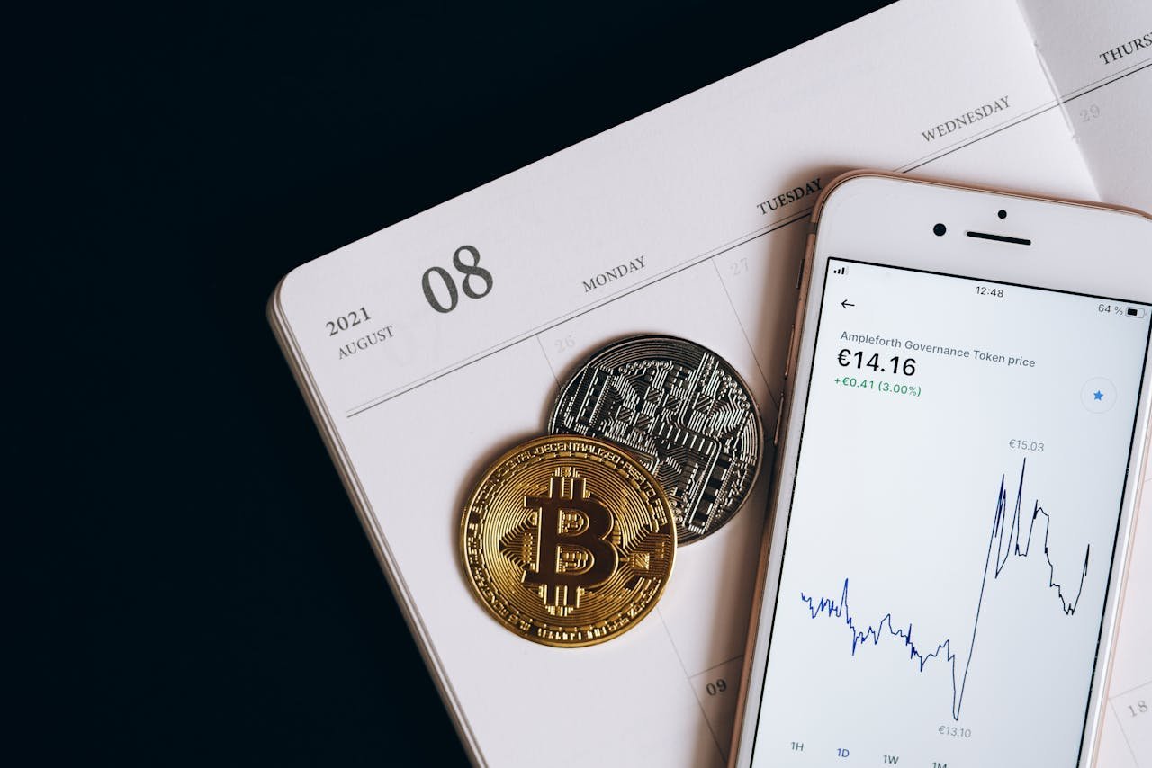 A smartphone displays cryptocurrency data alongside Bitcoin and Ethereum coins on an August calendar.